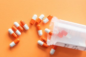 orange and white medication pill